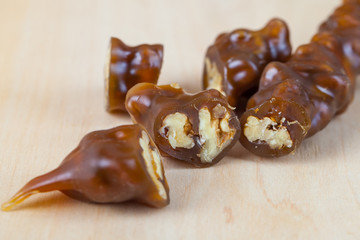 Tasty oriental sweets, churchkhela on the wooden table. Georgian national dessert