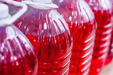 non-freezing glass-washing liquid of red color in a transparent bottle
