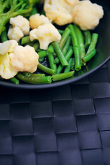 Healthy Green Organic Raw cauliflower, broccoli and French Cut Green Beans on a plate. concept of a healthy food and diet