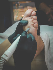 Process of pedicure at beauty salon. Close up.