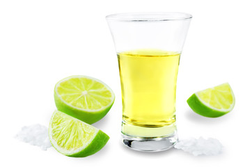 Glass of tequila liquor with salt and lime fruits isolated