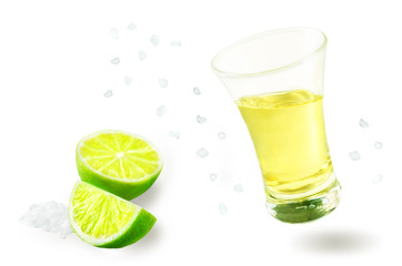 Glass of tequila liquor with falling salt and lime fruits isolated