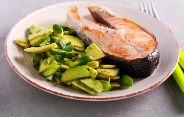 Fried fish steak and salad