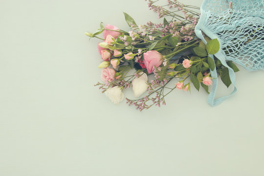 Fototapeta Image of aromatic flowers over pastel wooden table.
