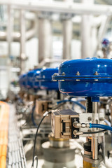 pneumatic valves in a row in a large industrial plant