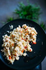 Homemade Chicken Risotto with Onion and Carrot on Dark Background