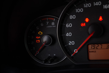Close up shot of a speedometer in a car.