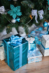 Fototapeta na wymiar boxes with Christmas gifts are under the tree New Year