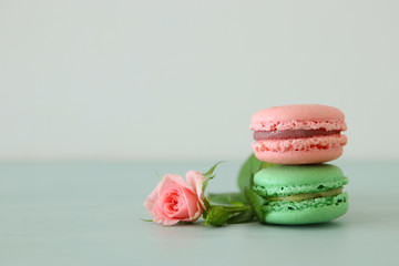 Image of romantic colorful macaron or macaroon over pastel background.