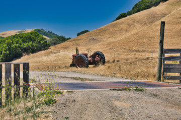 Red tractor let out on a farm's dry field