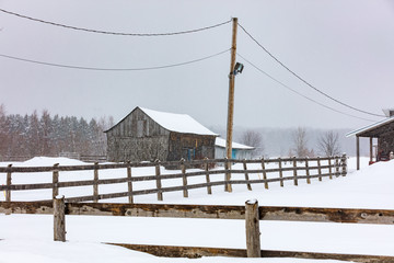 Antique barn in a snowy winter scene in rural Quebec, Canada. - 231395223