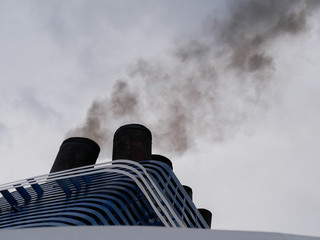 Coal black smoke from the ferry exhaust pipe.