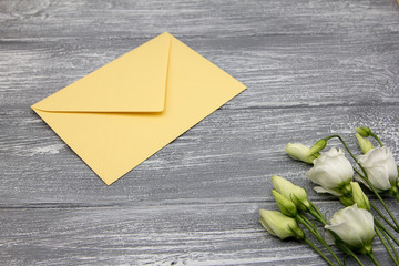 Bouquet Eustoma and envelope gray vintage background congratulations Women's Day, a compliment a...