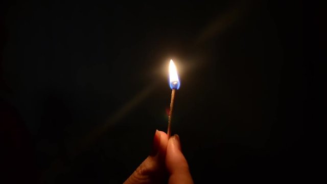 ignited and lit a match in the dark