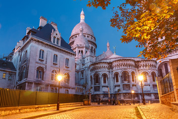 Fototapeta na wymiar Empty cozy street and the Sacre-Coeur Basilica during morning blue hour, quarter Montmartre in Paris, France