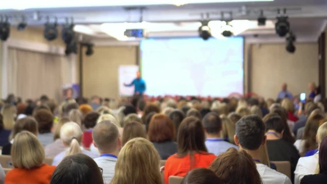 people at a conference or presentation, workshop, master class photograph. Back view. It is a lot of people.