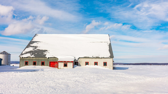 Antique barn in rural Quebec Canada after a snow storm.