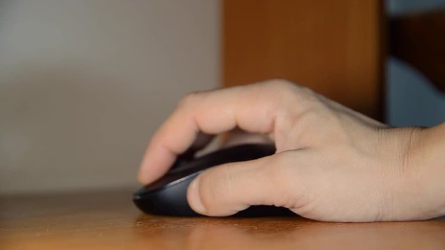 man presses his finger on computer mouse