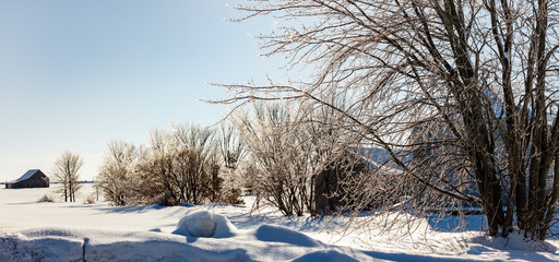 Antique barn in rural Quebec Canada after a snow storm.