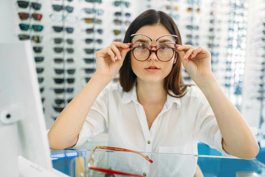 Female buyer tries on many glasses at same time