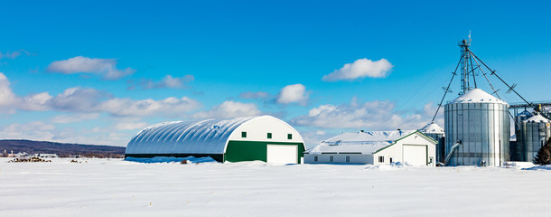 Antique barn in rural Quebec Canada in a snowy seasonal background.