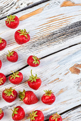 Fresh strawberries and copy space, top view. Border from tasty berries on vintage wooden background. Sweet seasonal fruits.