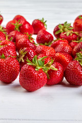 Group of ripe healthy strawberries. Organic strawberries on white background, vertical image.