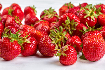 Ripe strawberries background. Tasty fragrant berries. Wholesome seasonal fruit.