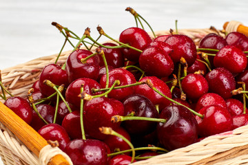 Sweet delicious cherries close up. Healthy summer berries in basket. Food and nature.