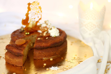 Dried apricot cake with mascarpone frosting, decorated for Christmas. Selective focus.
