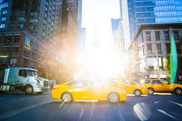 Yellow Taxi Cabs in New York city with bright sun shining