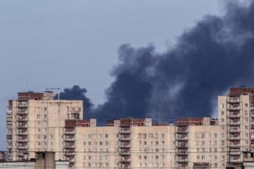 Fire. There is smoke above the houses. Smoke from the fire over the city.