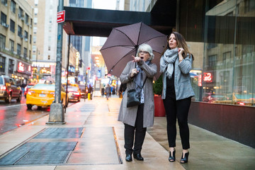 Two women pointing and looking while on vacation in New York