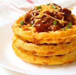 Close up of Cornbread cheddar waffles with bean chili isolated on white