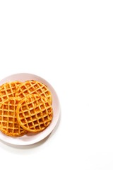 Homemade Pumpkin cornmeal waffles isolated on white top view