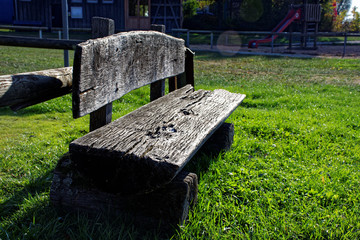 old forgotten bench in a green meadow