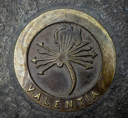 metallic symbol of Valencia city (Valentia in Latin) on the floor