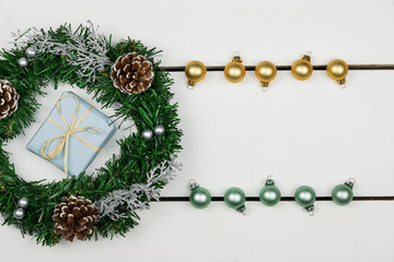  Presents with a pine branch and decorations on a background of white wooden boards