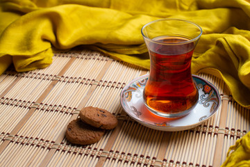 Homemade oatmeal cookies with a cup of tea on old wooden background