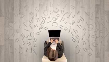 Letters with writer using tablet in a beige chair and an office space
