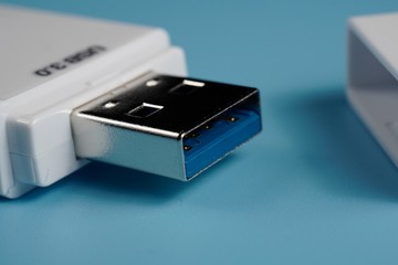 A USB 3.0 SD and microSD card reader isolated blue background
