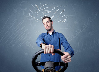 Young man holding black steering wheel with white scribbles around him
