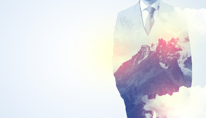 Businessman standing and thinking with snowy mountain graphic