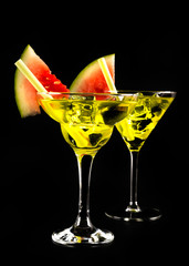 green refreshing drink on the basis of pear with decorated watermelon on a black background