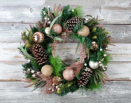 Christmas Holiday Wreath With Illuminated Lights On Rustic White Wood
