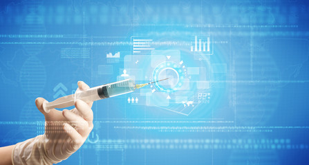 Female doctor hand holding syringe with blue background and charts