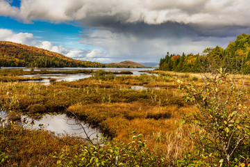 Fall colors of Lac Legault with Mont Kaaikop in the background, in cottage country in the Laurentians, Quebec, Canada.