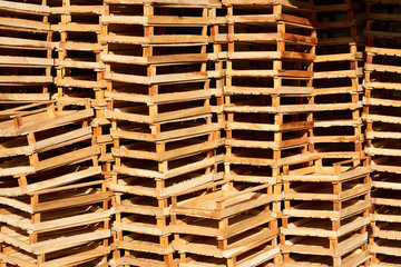 Empty wooden crate for fruits and vegetables stacked in a market warehouse, close-up. Wooden boxes background, outdoors