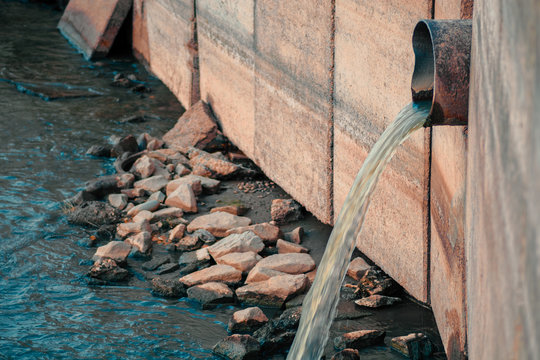 City Polluting the environment. Drainage pipe discharging waist products directly into the river