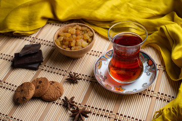 Homemade oatmeal cookies with a cup of tea on old wooden background, A cup of tea with raisin, a cup of tea with chocolate